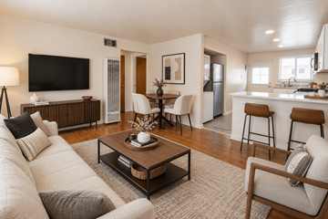 Wheat Ridge apartment for rent - A modern living room with a white couch and a wooden coffee table.