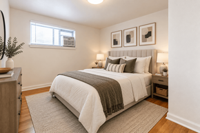 Wheat Ridge apartment for rent - A bedroom with a large bed and a window.