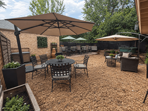Denver apartment for rent - A patio with a table and chairs under an umbrella.