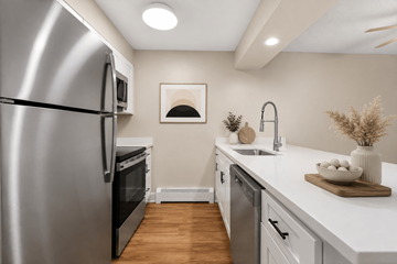 Boulder apartment for rent - A modern kitchen with a stainless steel refrigerator and wooden flooring.
