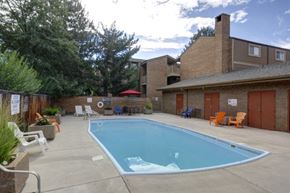 Boulder condo for rent - A small pool in a backyard with a patio and chairs.