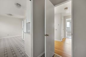 Englewood apartment for rent - A hallway with a checkered floor and white walls.