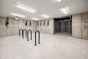 Boulder apartment for rent - A gym with a concrete wall and a row of black pull-up bars.