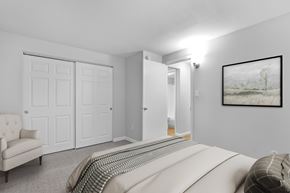 Denver apartment for rent - A bedroom with a large bed and a painting on the wall.