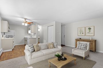 Denver apartment for rent - A living room with a white couch and a coffee table.