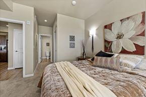 Fort Collins apartment for rent - A bedroom with a large bed and a painting on the wall.