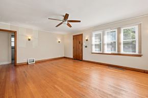 Denver apartment for rent - A room with a ceiling fan and wooden floors.