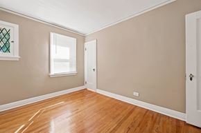 Denver apartment for rent - A room with a wooden floor and a white door.