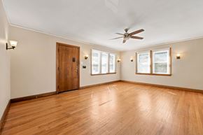 Denver apartment for rent - A room with a ceiling fan and wooden floors.