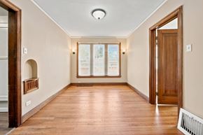 Denver apartment for rent - A long hallway with wood floors and a white ceiling.