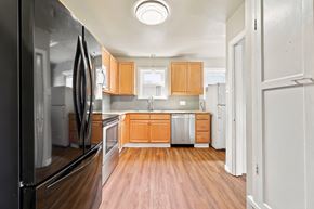 Denver apartment for rent - A kitchen with wooden floors and white walls.