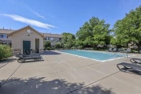 Thornton townhouse for rent - A pool area with a small building and a bicycle.