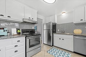 Lakewood apartment for rent - A kitchen with a black stove top oven and a silver refrigerator.