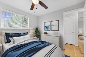 Lakewood apartment for rent - A bedroom with a bed, dresser, and ceiling fan.