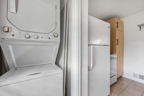 Denver apartment for rent - A white washing machine and a white fridge in a kitchen.