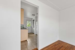 Denver apartment for rent - A kitchen with white walls and wooden floors.