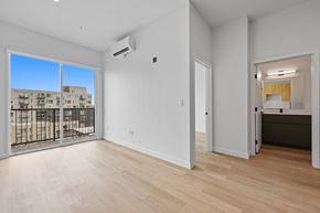 Denver apartment for rent - A spacious room with a sliding glass door leading to a balcony.