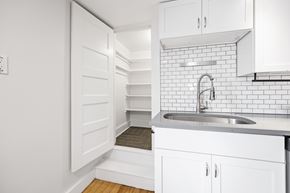 Denver apartment for rent - A kitchen with white cabinets and a white sink.