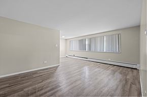 Denver apartment for rent - A room with wooden flooring and a window with blinds.