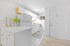 Englewood apartment for rent - A kitchen with white cabinets and a white island.