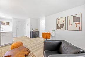 Englewood apartment for rent - A living room with a grey couch and a wooden table.