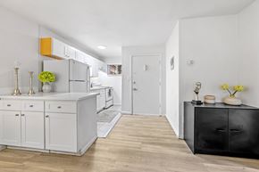 Englewood apartment for rent - A kitchen with white cabinets and a black dresser.