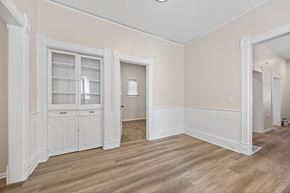 Denver apartment for rent - A room with a wooden floor and white trim.