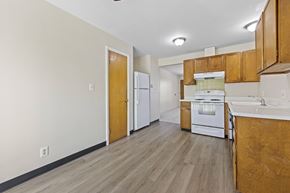 Lakewood apartment for rent - A kitchen with white appliances and wooden cabinets.