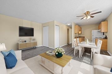 Commerce City apartment for rent - A living room with a white couch and a wooden coffee table.
