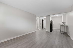 Lakewood apartment for rent - A spacious room with a kitchenette and a refrigerator.