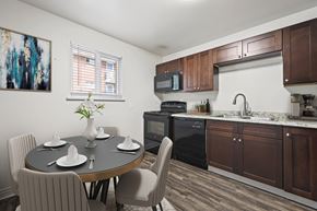 Arvada apartment for rent - A kitchen with a table set for four with a painting on the wall.