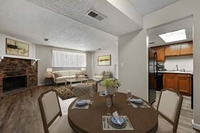 Aurora apartment for rent - A dining room with a table set for two and a couch in the background.