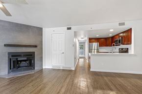 Boulder apartment for rent - A spacious living room with a fireplace and hardwood floors.