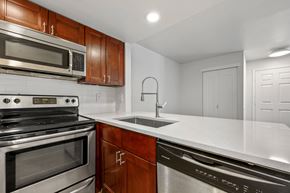 Boulder apartment for rent - A modern kitchen with a stainless steel dishwasher and a black oven.
