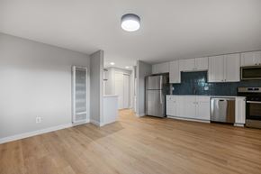Boulder apartment for rent - A kitchen with white cabinets and a wooden floor.