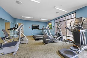 Denver apartment for rent - A gym with treadmills, elliptical machines, and other exercise equipment.