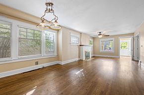 Denver apartment for rent - A room with wooden floors and a chandelier.