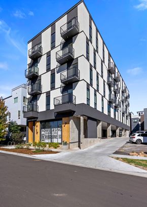 Denver apartment for rent - A modern apartment building with balconies on the second floor.