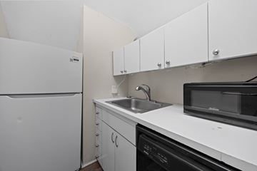 Denver apartment for rent - A white fridge and microwave in a kitchen.