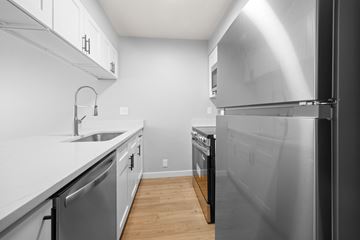 Boulder apartment for rent - A modern kitchen with a stainless steel refrigerator and a white countertop.
