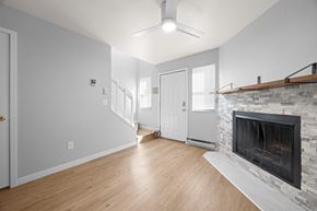 Boulder apartment for rent - A room with a fireplace and a ceiling fan.