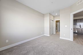 Arvada apartment for rent - A spacious living room with a carpeted floor and a doorway leading to another room.