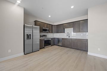 Arvada apartment for rent - A modern kitchen with wooden floors and stainless steel appliances.