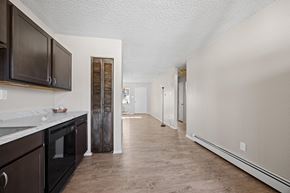 Lakewood apartment for rent - A kitchen with dark brown cabinets and a white countertop.