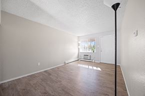 Lakewood apartment for rent - A room with a white ceiling and wooden flooring.