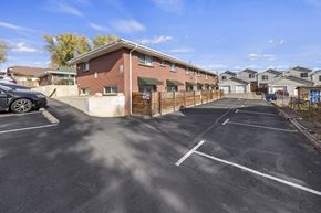 Lakewood apartment for rent - A parking lot with a building in the background.