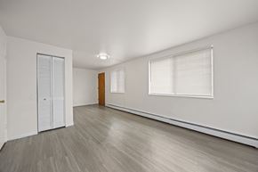 Westminster apartment for rent - A room with a white door, a brown door, and a window with blinds.