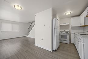 Westminster apartment for rent - A kitchen with white appliances and cabinets.