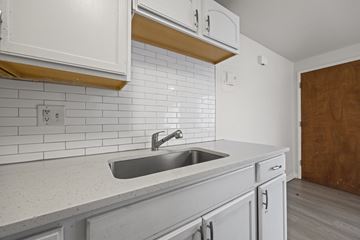Westminster apartment for rent - A kitchen with white cabinets and a white sink.
