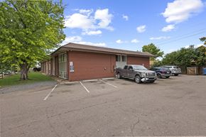 Denver apartment for rent - A parking lot with a building and cars.